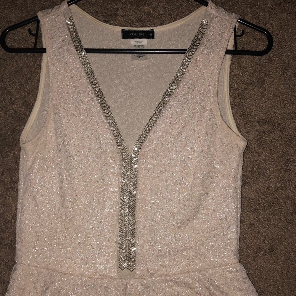 Cream colored, V-neck dress with sparkly finish.